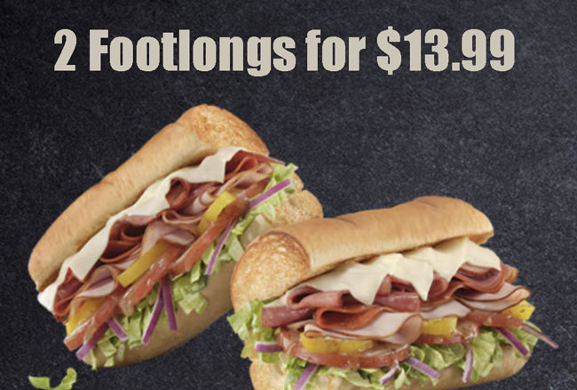 The sandwiches filled with meats, vegetables, and condiments on freshly baked bread.